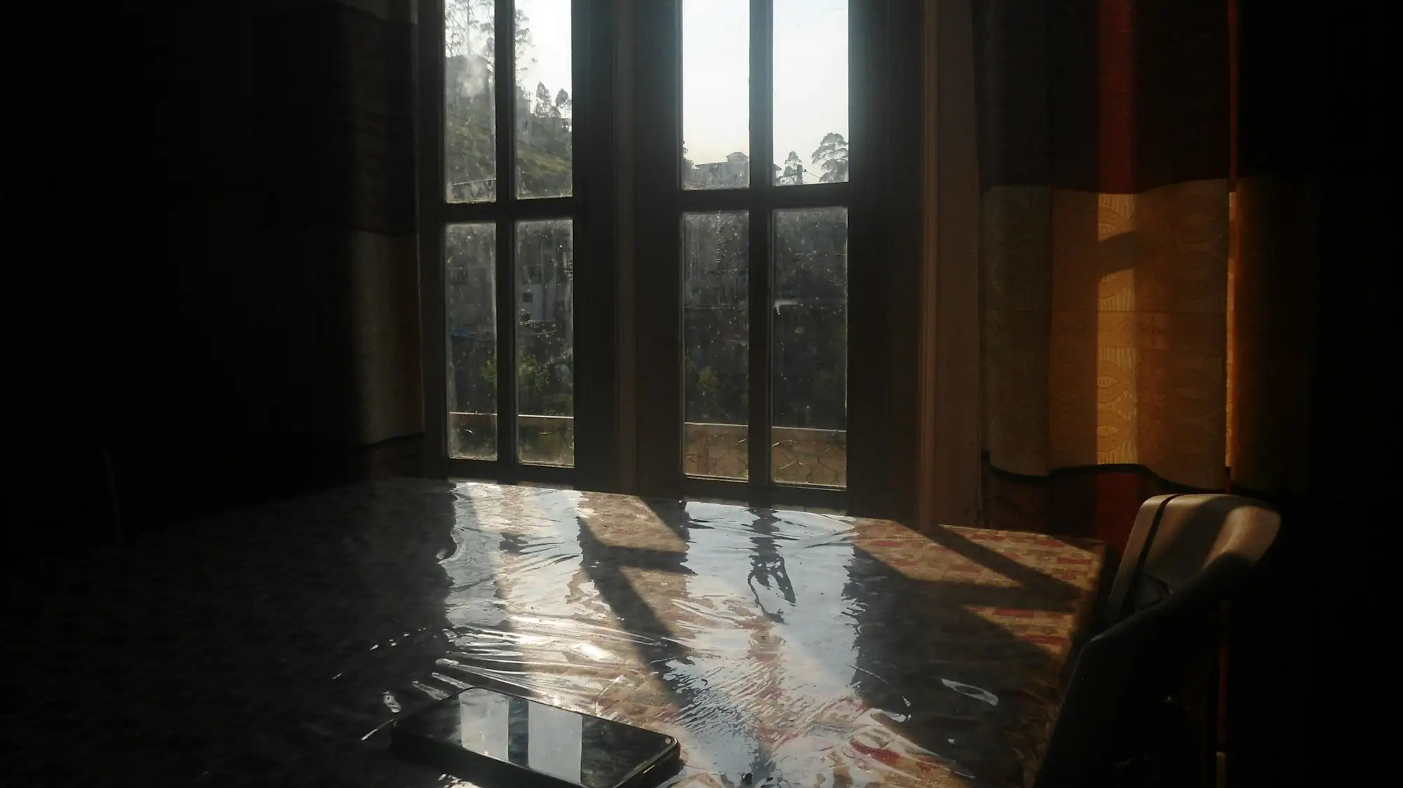 Sunlight reflecting on standing water across a room floor